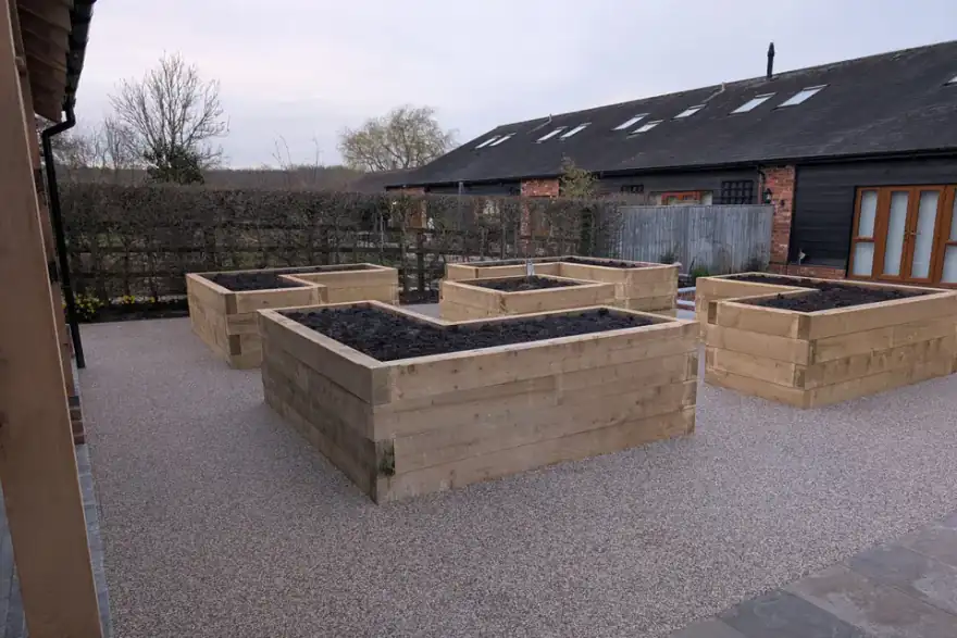 Raised wooden planters with a resin bound pathway
