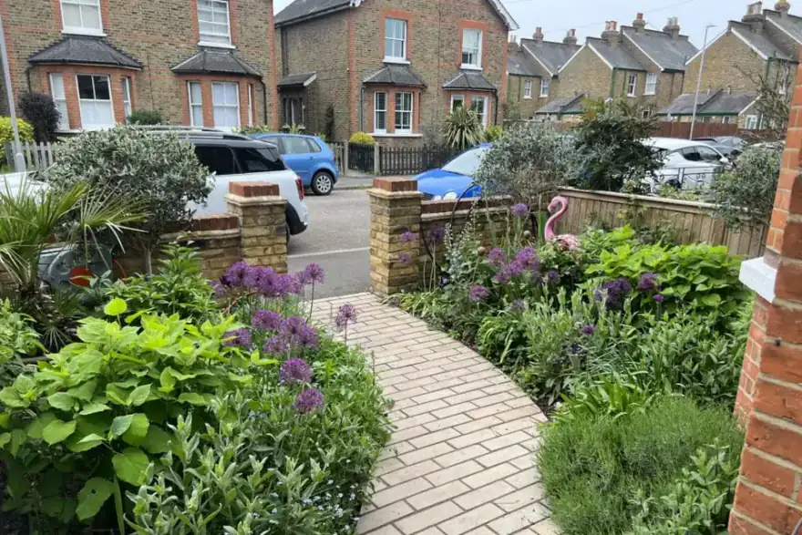 Victorian front garden with blooming flowers and structured planting