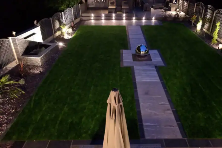 Water feature in the middle of a lawn at night