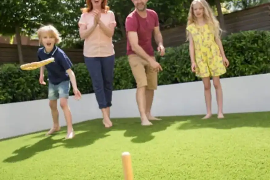 Family playing lawn games on artificial grass