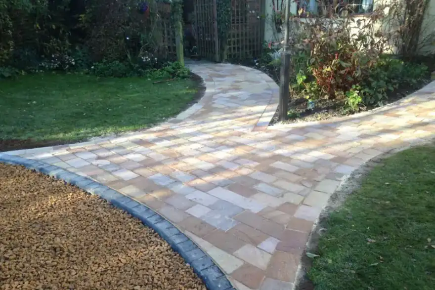 curved stone path from stone gravel area to garden
