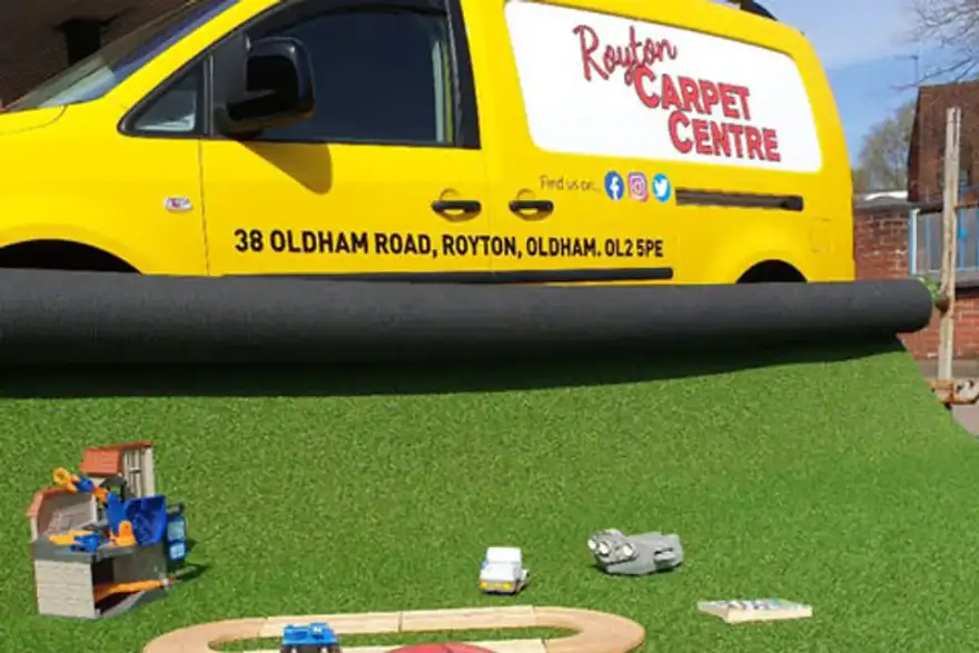 football on artificial grass with a yellow van in background