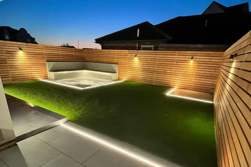 Contemporary garden at dusk with cedar slatted fencing and integrated LED strip lighting